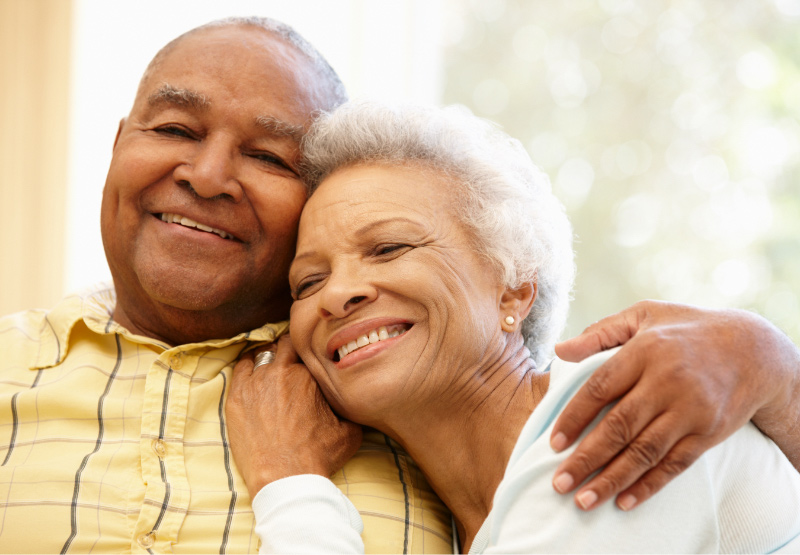Elderly couple smiling wife's head on husband's shoulder